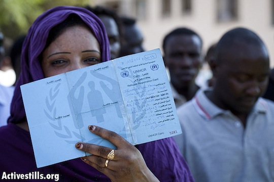 A Sudanese woman shows her UNHCR Refugee card from Egypt during a refugee protest in front of the government's offices in center Tel Aviv October 14, 2012. (photo: Oren Ziv/Activestills)
