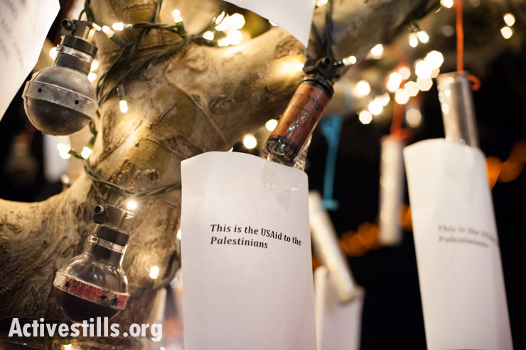 A sign hung by activists on a tree in Bethlehem's Manger Square among used tear gas and concussion grenades reads, "This is the USAid to the Palestinians." (photo: Ryan Rodrick Beiler/Activestills.org)