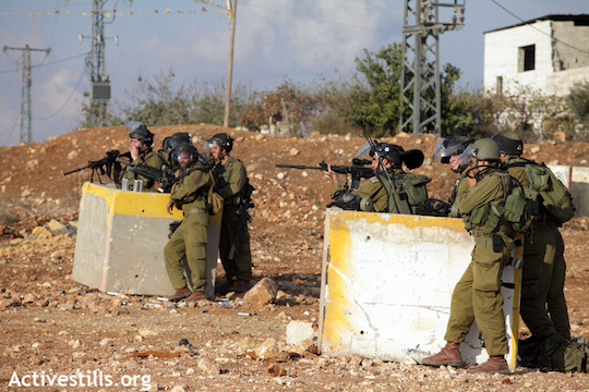 Illustrative photo of an Israeli soldier aiming his weapon at Palestinian protesters. (Photo: Anne Paq/Activestills.org)