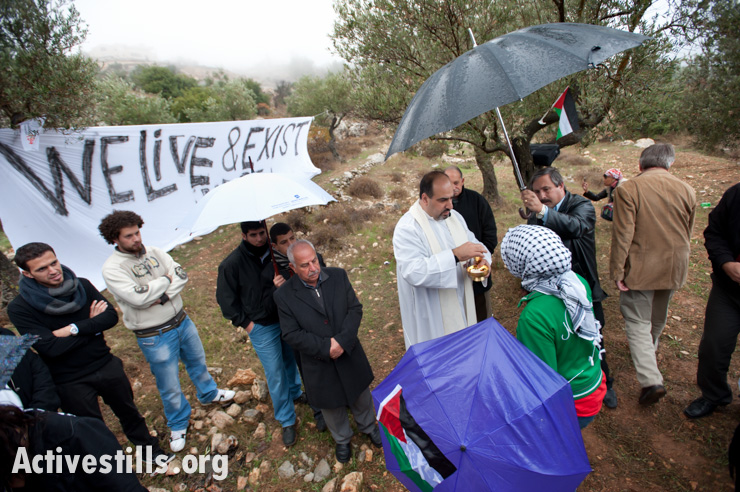 Bethlehem-area Christians joined by local and international activists gather for a Catholic mass to protest the Israeli separation wall that will cut off Beit Jala's Cremisan monastery and winery from nearby West Bank communities, November 18, 2011.