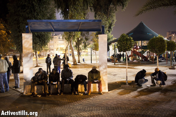 Homeless asylum seekers eat a meal provided by Israeli humanitarian organizations in south Tel Aviv’s Levinsky Park, January 24, 2012. (Photo: Oren Ziv/Activestills.org)