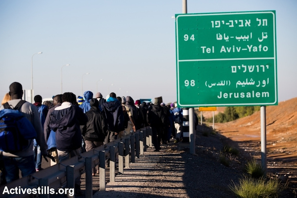 African Asylum seekers march out of the Holot ‘open prison,’ where they were being held, and march along the highway from Beer Sheva in southern Israel on their way to Jerusalem, December 16, 2013. (Photo: Activestills.org)