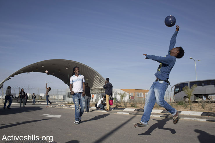 African asylum seekers held in the Holot detention center play outside as asylum seekers living in Tel Aviv and  Israeli activists held a solidarity visit, January 25, 2014. (photo: Oren Ziv/Activestills.org) 