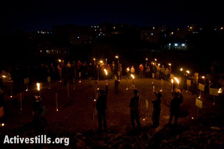 Relatives of Palestinians killed at the Ibrahimi Mosque in 1994 hold a candlelight vigil in the West Bank city of Hebron to mark the 15th anniversary since Jewish-Israeli Baruch Goldstein opened fire on worshipers, killing 29 people and wounding another 125, February 25, 2009.