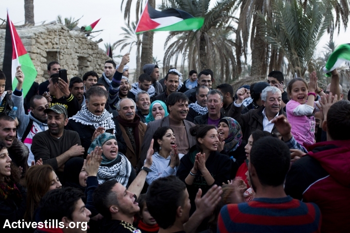 Palestinian activists celebrate as they arrive to Ein Hijleh protest village, in the Jordan Valley, West Bank January 31, 2014. 