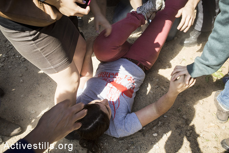 Sapir Slotzker, an activists after being pushed on the ground by Israeli border police, March 27, 2014. Sapir was later arrested by the police. (Shiraz Grinbaum/Activestills.org)