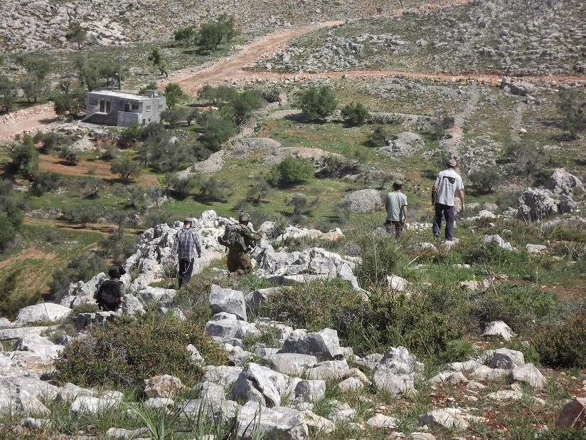 Settlers and Israeli soldiers seen in Burin, West Bank. (photo: Yesh Din)