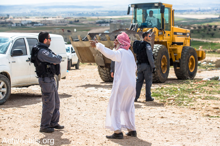 An old men shouts at Israeli police men after  authorities bulldozer demolished a building in the Bedouin village of Kuhle on February 26, 2014.  Every year around 1000 buildings are demolished in in the Bedouins towns and villages in the south of Israel. (photo: Yotam Ronen/Activestills.org)