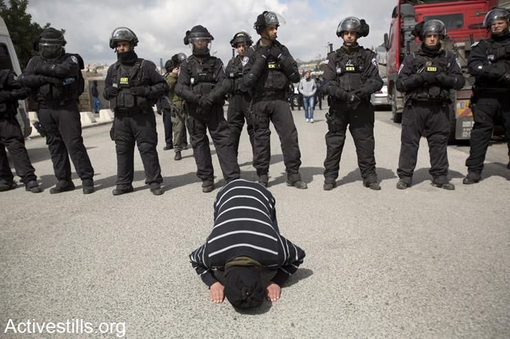 Palestinians pray outside Al-Aqsa Mosque after Israeli police limited access to the mosque for young worshipers to prevent possible clashes, Ras al-Amud, East Jerusalem, March 14, 2014. (photo: Activestills.org)
