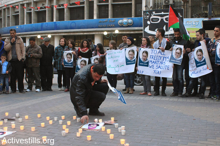 Palestinian and international activists commemorate the death of Rachel Corrie in the city center of Nablus, West Bank, March 16, 2014. Rachel Corrie, an American activist, was killed on March 16, 2003 by an Israeli military bulldozer in Rafah, Gaza Strip, as she tried to block a demolition of a Palestinian home. (photo: Activestills.org)