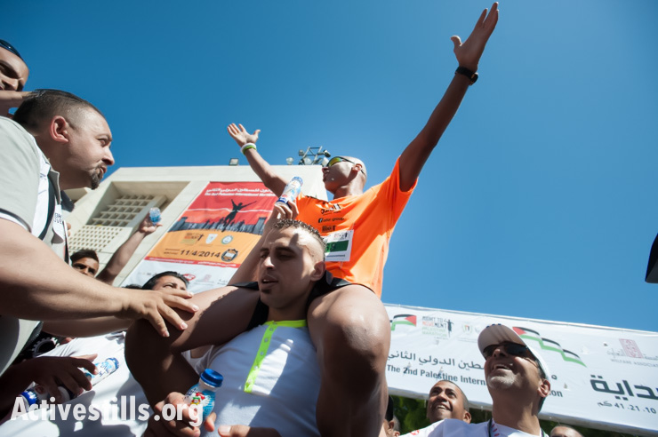 Last year's winner, Abdel Nasser Awajneh, a Palestinian from Jericho, placed third after two Danish runners in the second annual Palestine Marathon in the West Bank town of Bethlehem, April 11, 2014. (photo: Activestills.org)