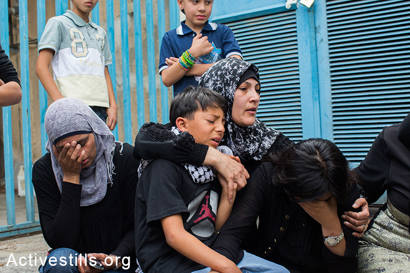 Relatives of Nadim Seeam Abu Kara mourn in the hospital before his funeral procession in the West Bank city of Ramallah on May 16, 2014. Abu Kara and Muhammad Abu Da'har were shot dead by Israeli forces during clashes the previous day outside the Israeli-run Ofer prison following a protest commemorating the Nakba. Foreign press published that the two died in a Ramallah hospital after being shot in the chest during a protest to demand the release of thousands of Palestinians held by Israel. (Activestills.org)