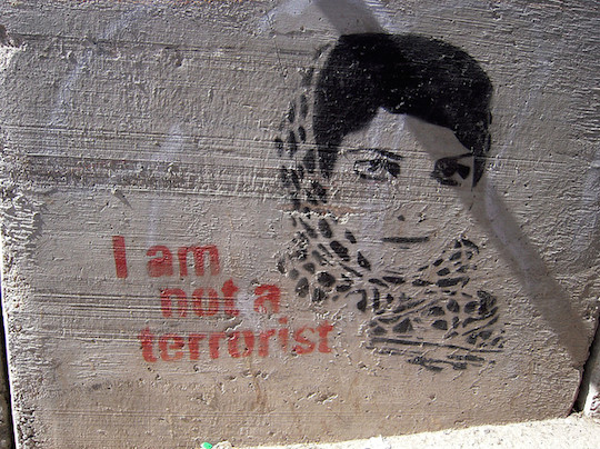 A graffiti stencil inside a Bethlehem-area checkpoint featuring the image of Leila Khaled. (Photo: Katsumi3/CC)