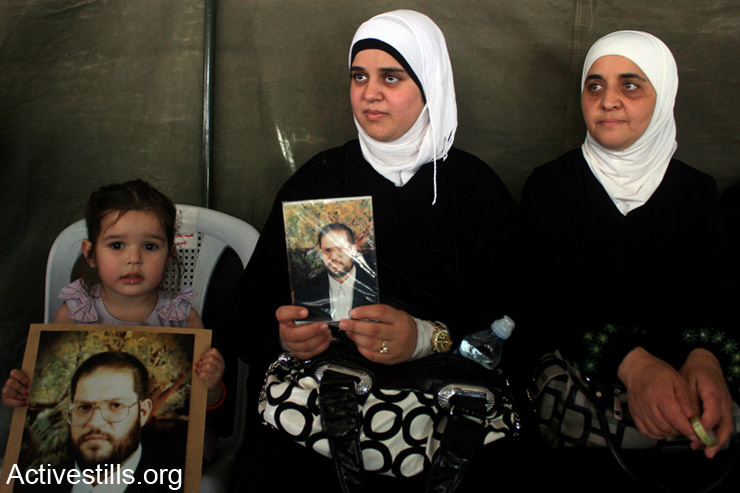The family of Bahaa Yaish hold his picture in a protest tent in Nablus city, West Bank, May 3rd, 2014. Yaish is a Palestinian administrative prisoner who spent 10 months in the Israeli prison. More than 100 Palestinian administrative prisoners in Israeli prisons launched a mass, open-ended hunger strike on Thursday, April 24, 2014, at the Ofer, Megiddo, and Negev prisons. The strike came after Israeli authorities reneged on a promise to limit the use of administrative detention to exceptional cases.
