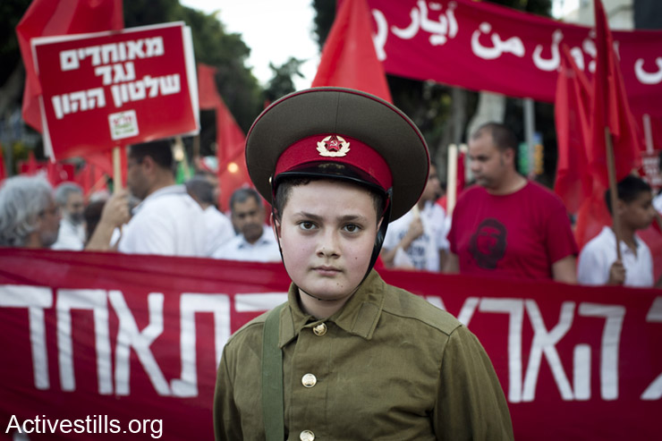 A youth dressed with uniform of the USSR army, marches during a protest marking the International Worker's Day in center Tel Aviv, May 1, 2014.