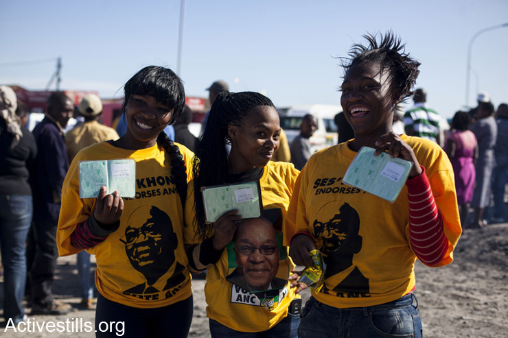 Three "Free Borns" voters showing there ID books at the SST voting center Khaletisha, Western Cape, South Africa, 7.5.2014. "Free Borns" are South Africans that were born after the fall of apartheid. On May 7th 2014, South Africans went to vote for the fifth time since apartheid ended. The ANC (African National Congress) lead by Jacob Zuma is expected to win and stay despite being accused of corruption.