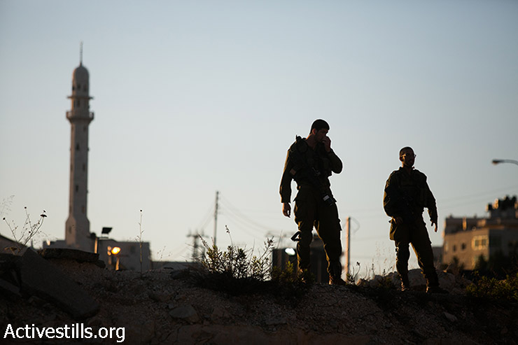 Israeli soldiers surround the West Bank city of Hebron, seen on June 15, 2014. (Yotam Ronen/Activestills.org)