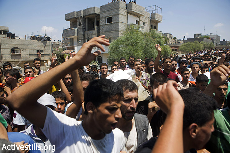 Palestinians shout with anger during the funeral.