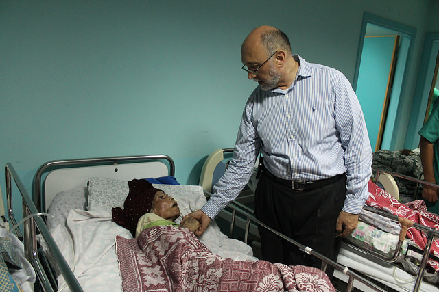 Basman Alashi, executive director of el-Wafa Hospital in eastern Gaza City, comforts a patient hours after an Israeli projectile struck the hospital's fourth floor Friday evening, demolishing a wall and damaging doors and windows. (photo: Joe Catron)