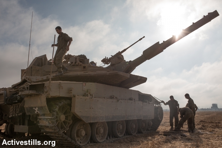 An Israeli tank is seen before entering the Gaza Strip near Israel's border with the Gaza strip on July 24, 2014. (photo: Activestills)