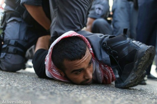 Police arrest a Palestinian-Israeli protester during a demonstration against Operation Protective Edge, July 18, 2014, Haifa, Israel (photo: Activestills)