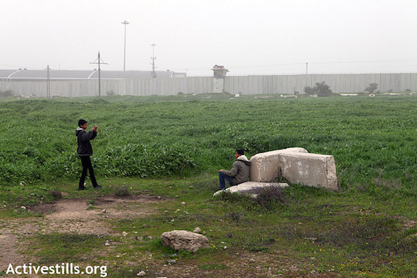 Palestinian children take pictures of each other in the No-go zone near Erez crossing, during the weekly demonstration against the occupation in Beit Hanoun, Gaza Strip, Tuesday, February 7, 2012. Every Tuesday Palestinians and supporters march from Beit Hanoun into the "buffer zone" or the No-go zone , where the fertile land has been made inaccessible to Palestinians due to the imminent danger of shooting by the Israeli army. (Photo: Anne Paq/Activestills.org)