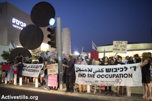 Left-wing activists during a protest in central Tel Aviv against the Israeli attack on Gaza, July 12, 2014. The protest ended with right-wing nationalists attacking a small group of left-wing activists with little police interference. (Photo by Oren Ziv/Activestills.org)