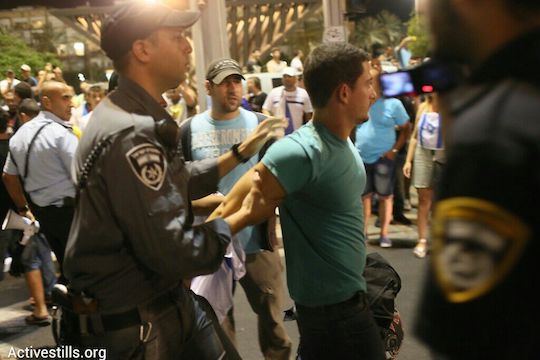 Rightist counter-protester arrested at a demonstration against the Gaza war in Tel Aviv, July 26, 2014. (photo: Activestill.org)