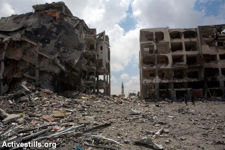A mosque minaret rises among the ruins of Al-Nada towers after they were destroyed by Israeli strikes in Beit Hanoun, northern Gaza Strip, August 4, 2014. The towers had 90 flats. So far, Israeli attacks have killed at least 1,870 Palestinians, and injured 9,470 since the beginning of the Israeli offensive (photo: Activestills)