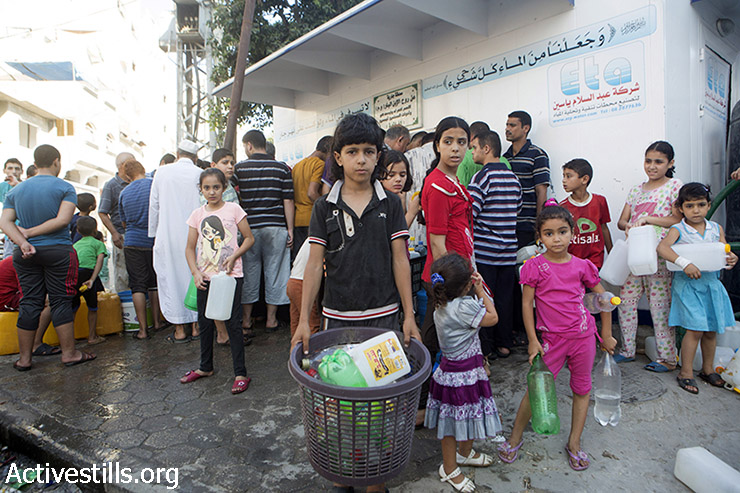Palestinians collect water in Shati' Refugee Camp, Gaza City, August 2, 2014. according to OCHA, 1.5 million People not in shelters have no or extremely restricted access to water in Gaza. (Basel Yazouri/Activestills.org)