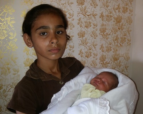 Rasha's sister holds the baby that was save (photo: Awni Farhat)