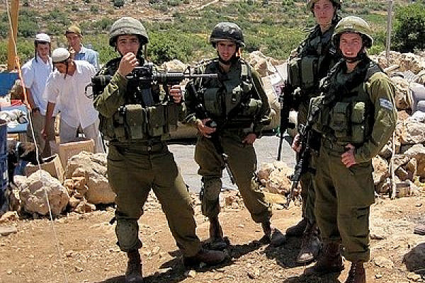 Israeli Soldiers Guard Settlers at an Illegal Outpost near Hebron. Photo: Mairav Zonszein)