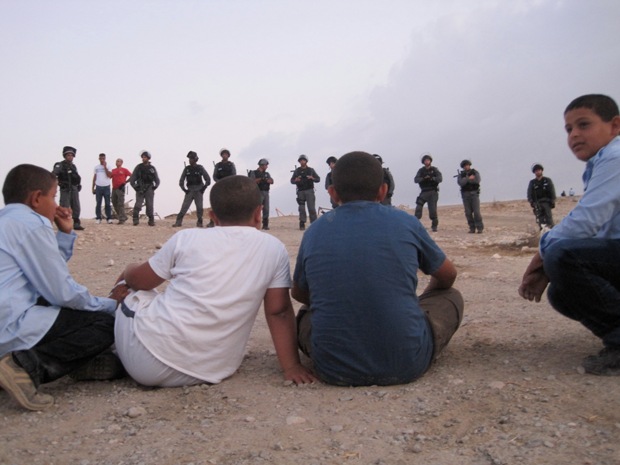 Children of Al-Araquib Watch as Israeli Armed Forces Prevent Non-Violent Demonstration Against the Razing of the Village. Photo by Mairav Zonszein