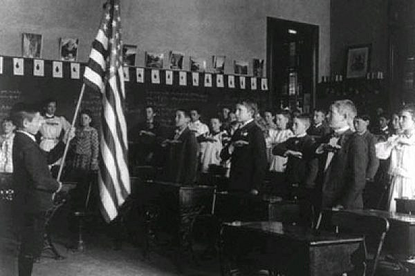 Pledging allegialnce to the flag in a US school, early twentieth century.