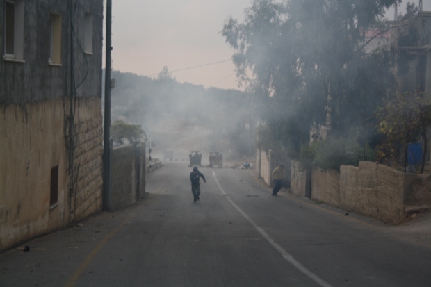 Palestinian Child in a Cloud of Tear Gas in Nabi Saleh on International Human Rights Day. Photo Credit: Joseph Dana