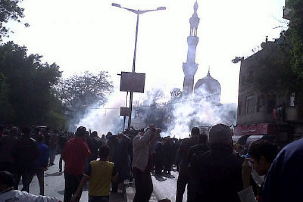 Demonstrators in Cairo, under tear gas attack (Flickr user Monasoh, creative commons license(