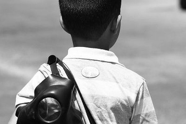 A child in Bil'in, carrying a gas mask (Yossi Gurvitz)