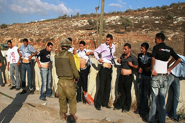Solider Inspecting Palestinians from Awarta. Photo: michaelramallah/Flickr