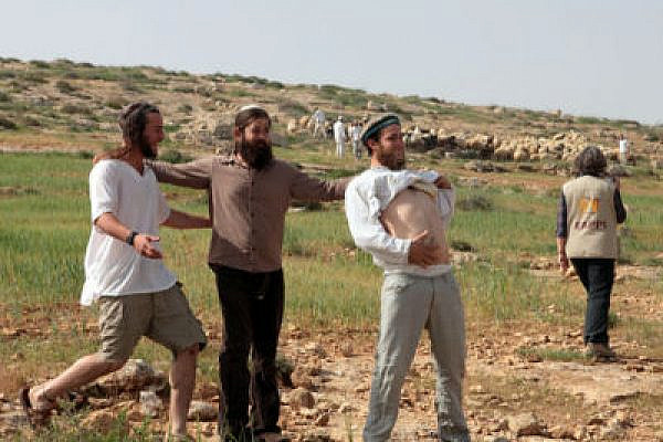 Settlers harass Palestinians in Susyia (Photo: Activestills)