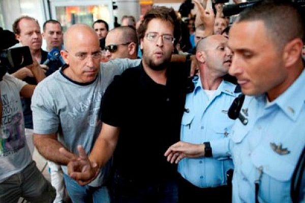 Israeli activist Matan Cohen being detained by police at Ben Gurion airport (photo: Oren Ziv / activestills.org)
