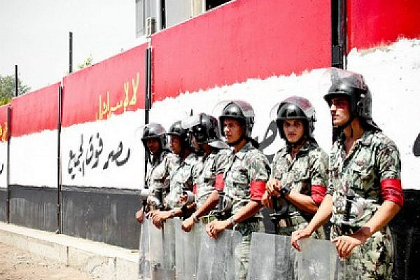 Egyptian soldiers next to the wall around the Israeli embassy building that was torn down by protesters yesterday (photo: flickr/maggie osama)