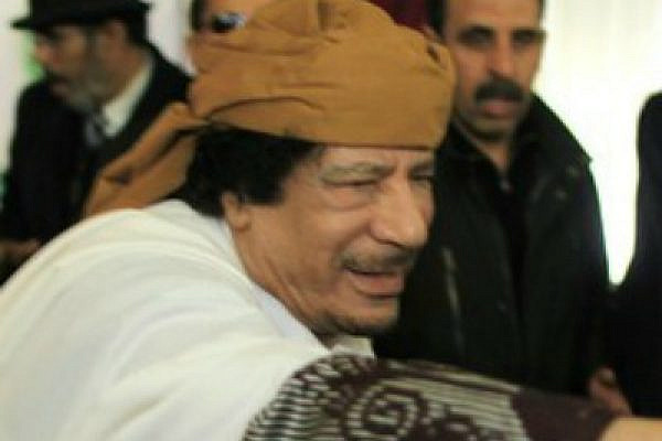 Libyan leader Muammar Gaddafi reaches out before making a speech in Tripoli which he sought to defuse tensions after more than 10 days of anti-government protests in Libya, March 2, 2011. (photo: Ahmed Jadallah/Flickr CC)