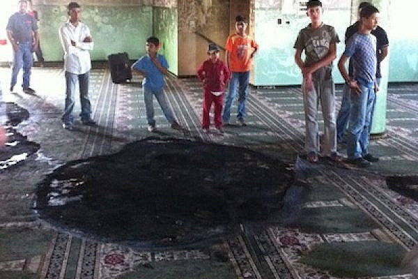 Palestinian children at a burnt mosque (Photo: Aziz Abu Sarah)
