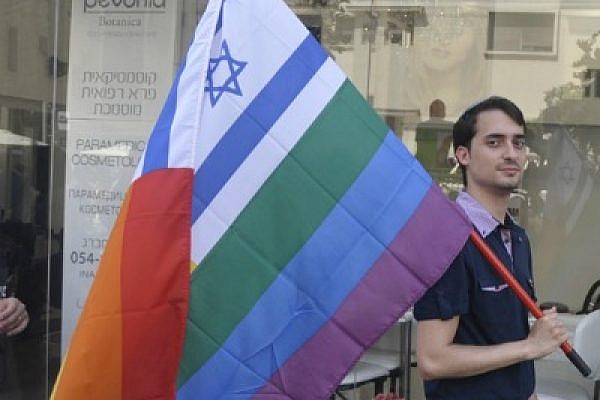 Israeli walks with flag during Tel Aviv gay pride (photo: wanderlasss/Flickr cc)