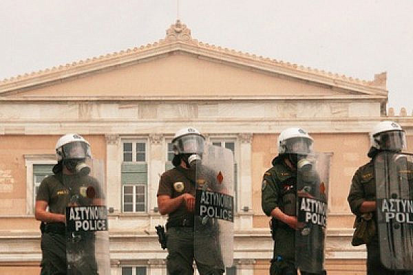 Greek riot police facing anti-austerity demonstrators (George Laoutaris/Flickr)