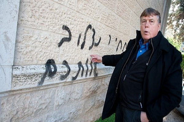 Pastor Chuck Kopp of the Baptist Narkis Street Congregation examines anti-Christian graffiti saying: "We will crucify you" (Photo:Ryan Rodrick Beiler)