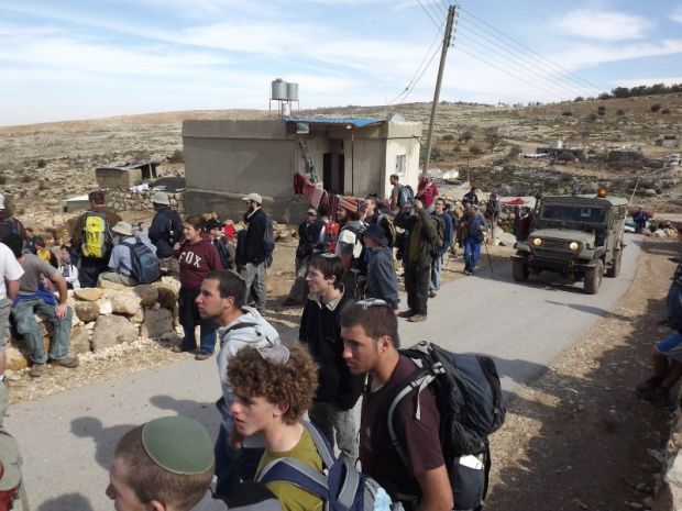 PHOTOS: Settlers march through Palestinian village