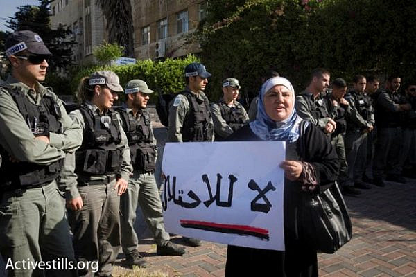 A Palestinian woman in front of policemen in Sheikh Jarrah, April 23 2010 (photo: Oren Ziv/ Activestills.org)