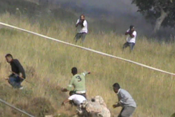 Two settlers from Itzhar shooting at Palestinians (from B'Tselem video)