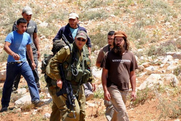 Settlers, accompanied by IDF gunmen, in South Hebron (Photo: B'Tselem)
